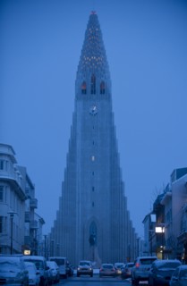 Monument overlooking Reykjavik city street at dusk