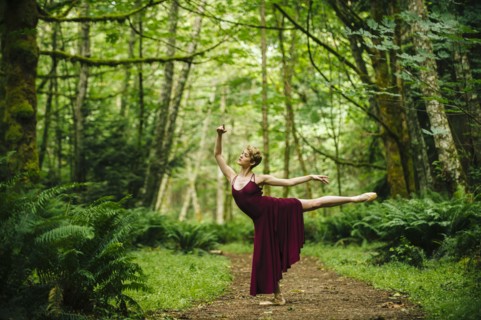 Caucasian woman dancing in forest