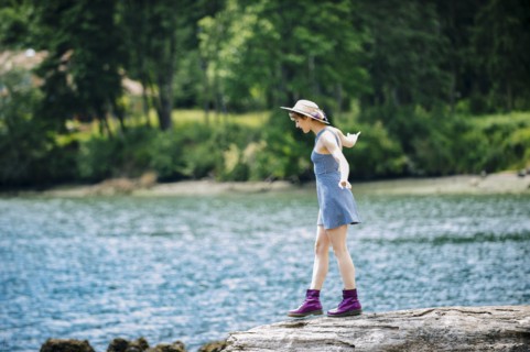 Caucasian woman walking on rock near river