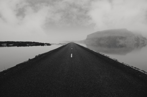 Paved road over still water