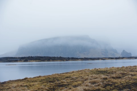 River near misty remote mountain