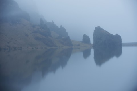 Rock formations and remote misty lake
