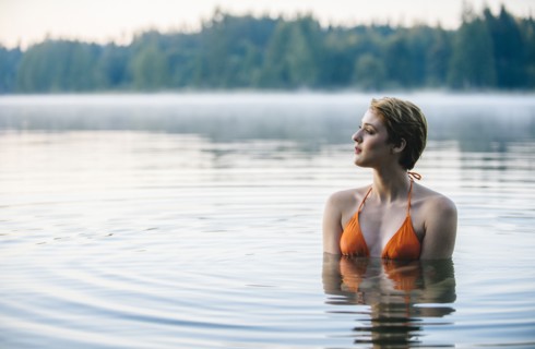 Caucasian woman swimming in still lake