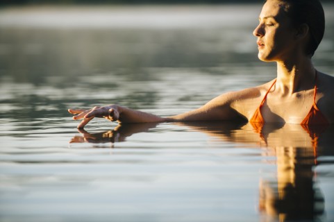 Caucasian woman swimming in still lake