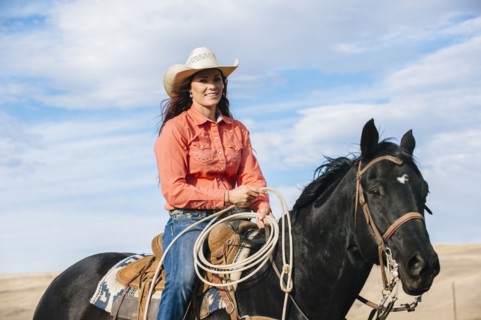 Caucasian woman smiling on horse