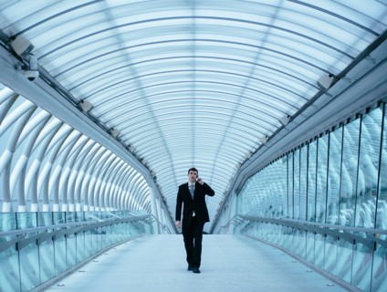 Caucasian businessman talking on cell phone in tunnel