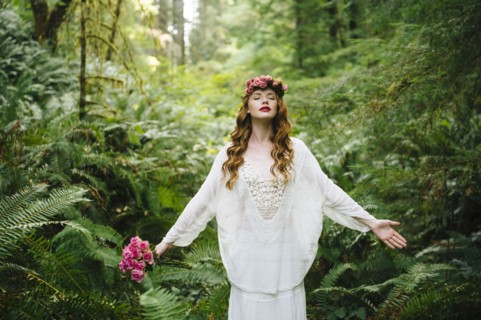 Caucasian woman wearing flower crown in forest