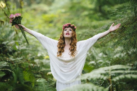 Caucasian woman wearing flower crown in forest