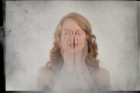 Double exposure of Caucasian woman covering face with hands