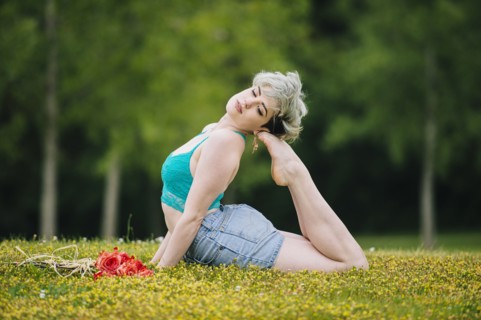 Caucasian woman laying in field arching back