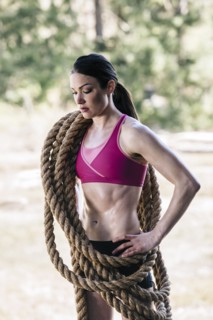 Caucasian woman carrying heavy ropes