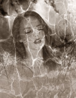 Multiple exposure of Caucasian woman and barren trees