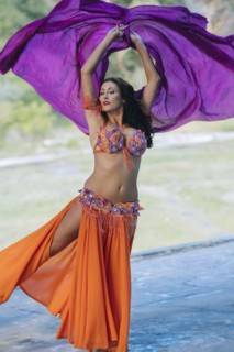 Belly dancer with arms raised