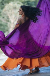 Belly dancer holding purple fabric