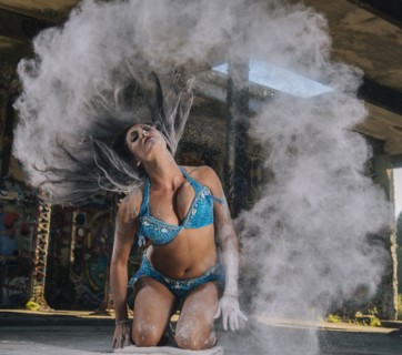 Belly dancer tossing hair with powder