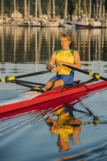 Caucasian man rowing on lake