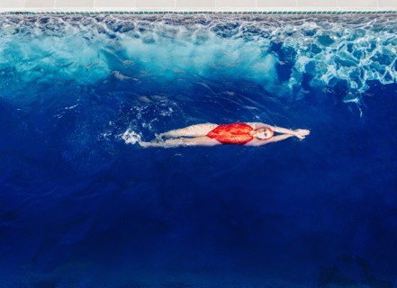 Caucasian woman swimming in swimming pool