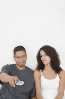 Hispanic couple watching television