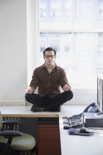 Hispanic businessman meditating