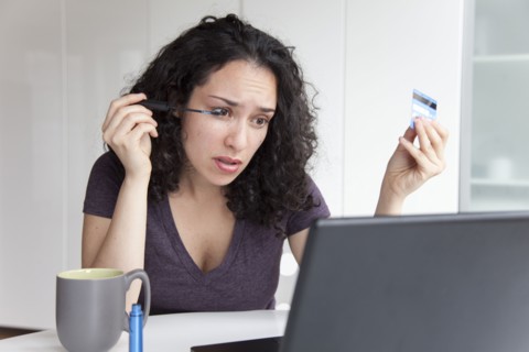 Hispanic woman putting on make up