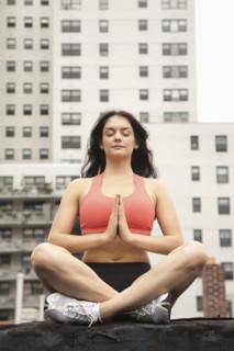 Woman practicing yoga on rooftop