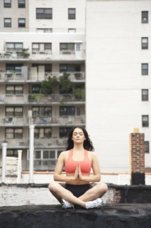 Woman practicing yoga on rooftop