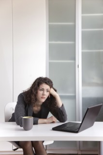Bored businesswoman sitting at desk