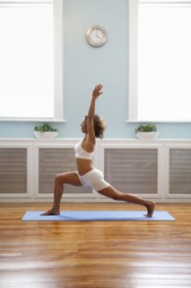 Mixed race woman practicing yoga