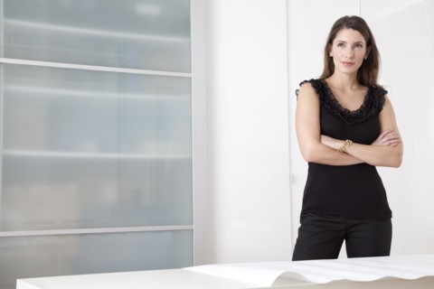 Caucasian architect standing with blueprints
