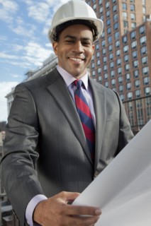 Black architect looking at blueprints