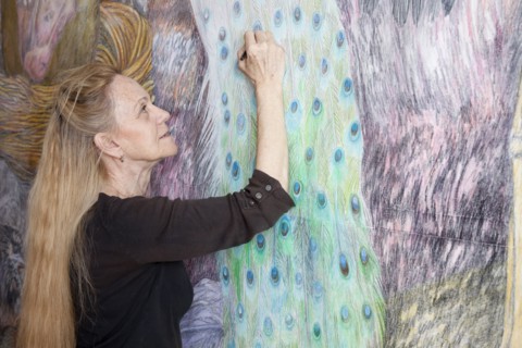 Caucasian woman drawing mural on wall