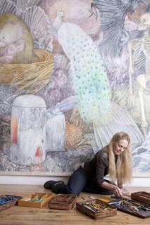 Caucasian woman drawing mural on wall