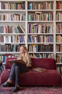 Caucasian woman sitting on sofa sketching
