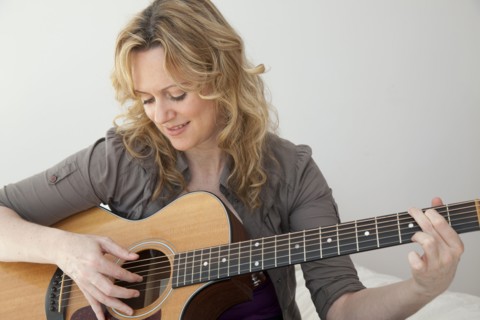 Caucasian woman playing guitar