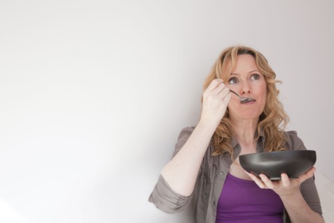 Caucasian woman eating soup