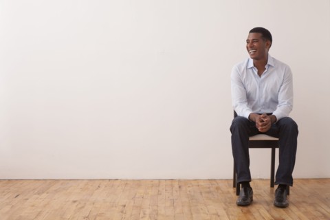 Black man sitting in chair