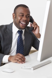 Black businessman talking on telephone at desk