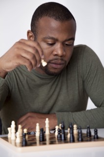 Black man playing chess
