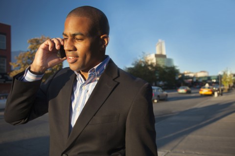 Black businessman talking on cell phone