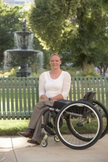 Disabled woman with wheelchair sitting on bench