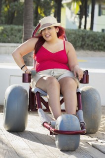 Paraplegic woman in wheelchair on walkway
