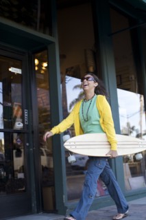 Mixed race woman carrying skateboard