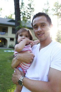 Father holding daughter outdoors