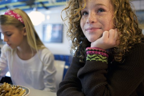 Caucasian girls eating in cafe