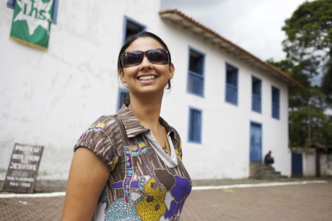 Smiling mixed race woman wearing sunglasses