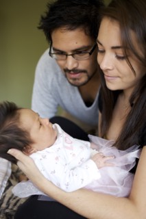 Mother and father looking at newborn baby