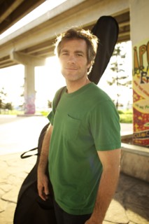 Smiling Caucasian man carrying double bass