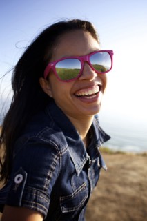 Smiling mixed race woman laughing on beach