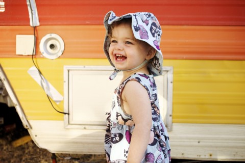 Laughing Caucasian girl near camper