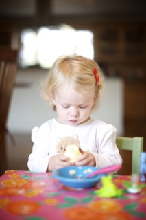 Hungry Caucasian girl eating food